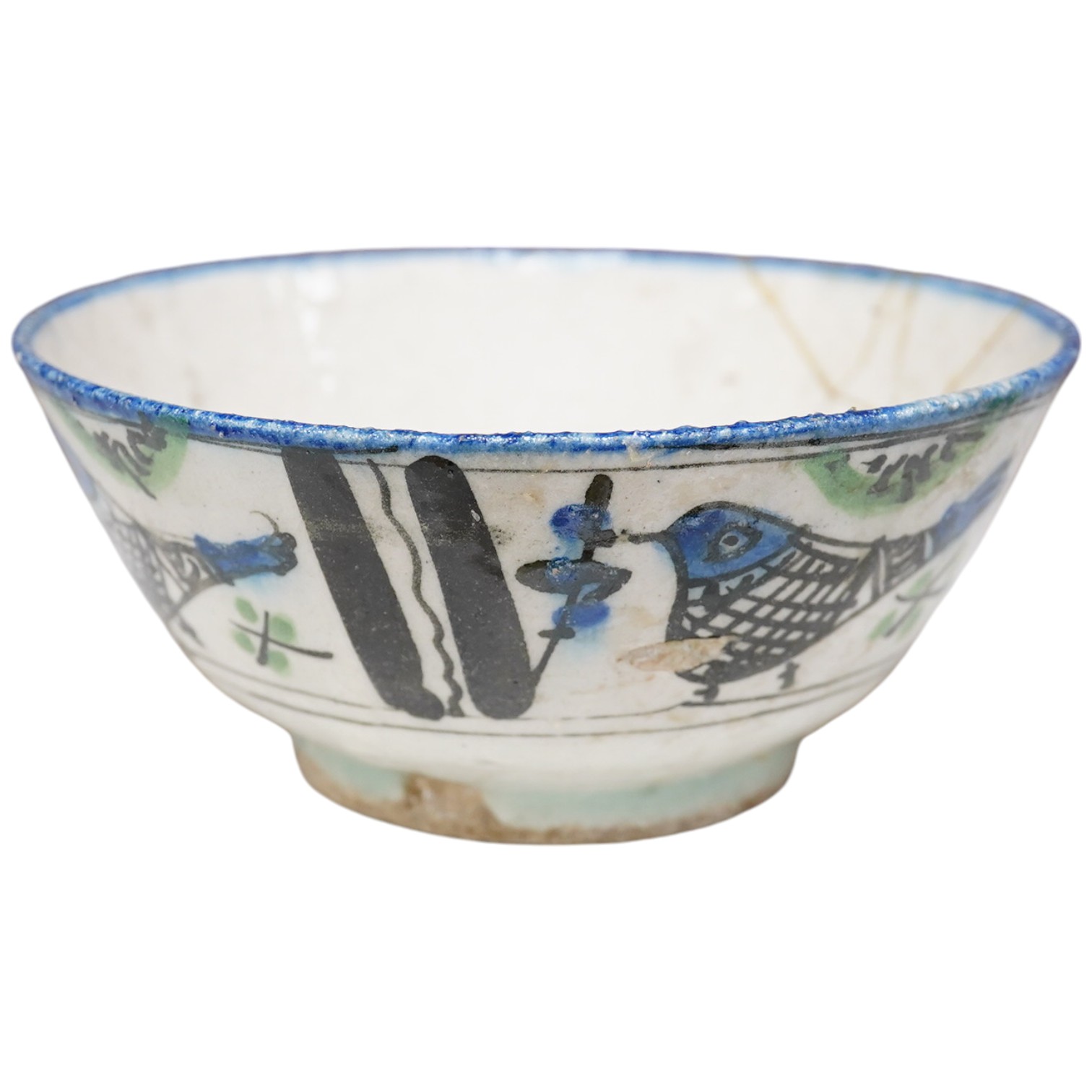 An 18th century Persian pottery bowl with bird decoration, 19cm diameter. Condition - poor